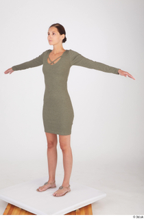 Vanessa Angel dressed green long sleeve dress standing t poses…